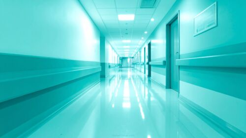 Aesthetic Medical Background PPT Hospital Hallway Scene by SlidesCorner.com