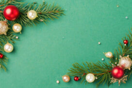 Green Christmas background with ornaments and tree branches