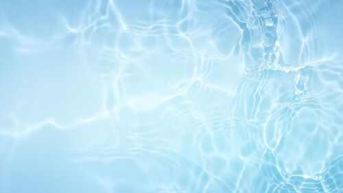 Crystal clear blue water background with soft ripples ideal for PowerPoint presentation slides and wallpaper