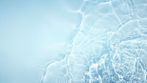 Crystal clear light blue water background with soft ripples for PowerPoint presentation slide or wallpaper