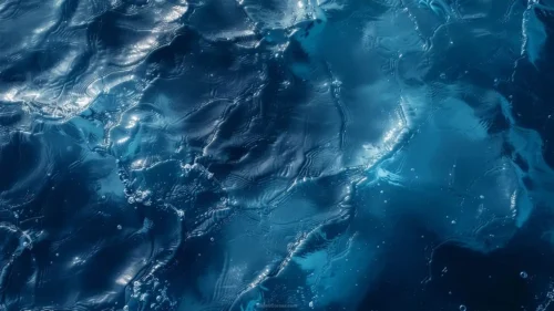 Top-down view of shiny blue ocean water waves HD background for Google Slides and PowerPoint