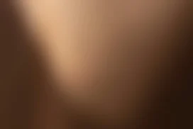 Brown Background with a Soft Curved Gradient Light Streak