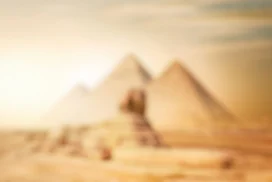 Egypt Pyramids Background for PowerPoint with Blurred Sphinx in Golden Desert Haze