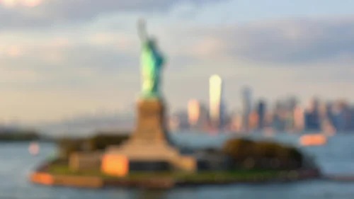 New York Background For PowerPoint With A Blurred Statue Of Liberty At Golden Hour