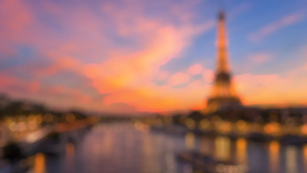 Paris Background for PowerPoint with a Blurred Eiffel Tower at Pink Orange Sunset over the Seine