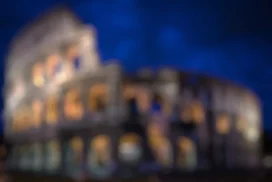 Rome Colosseum Night Background for PowerPoint with Blurred Amber Arches on Deep Blue Sky